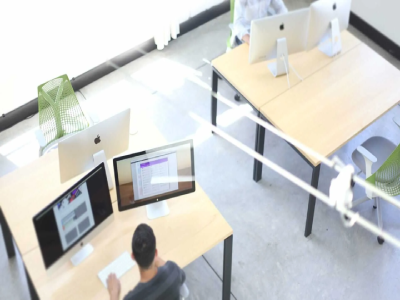 Professionals working at sleek desks with computers, embodying the dedication and innovation that define our team and our mission.