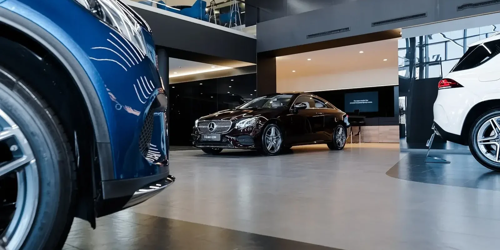 A modern car dealership showroom with luxury vehicles, illustrating the effectiveness of automotive PPC in Athens, Georgia, to attract potential buyers.
