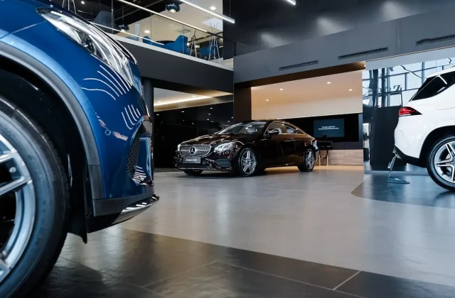 A modern car dealership showroom with luxury vehicles, illustrating the effectiveness of automotive PPC in Athens, Georgia, to attract potential buyers.