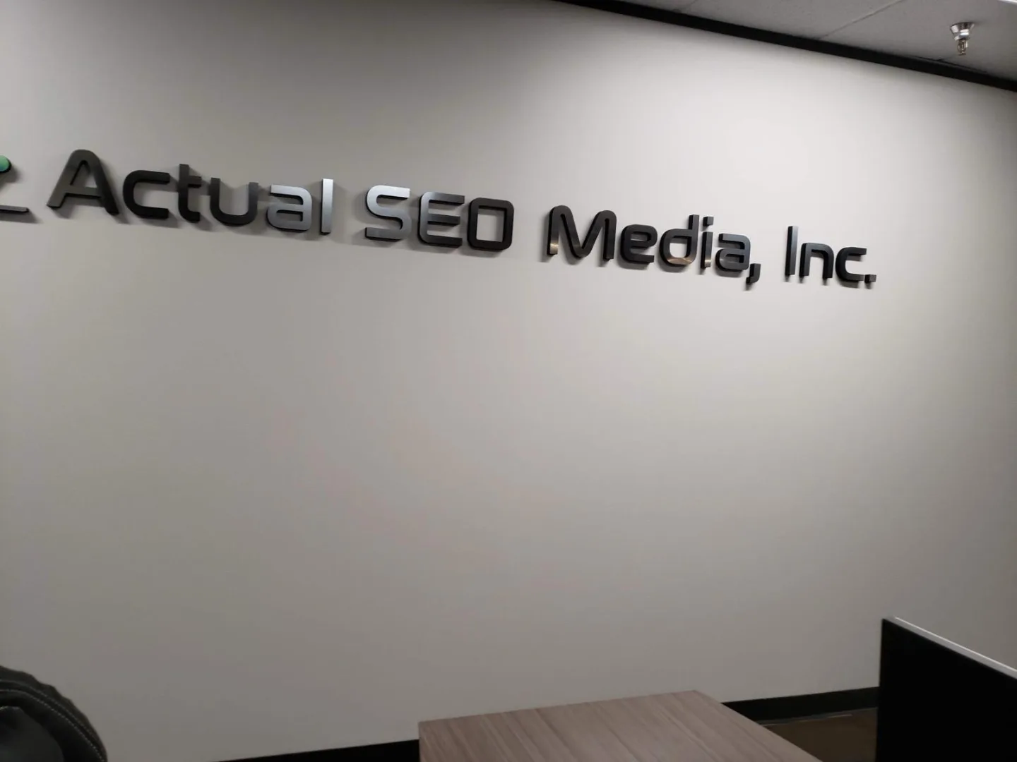 Actual SEO Media, Inc. logo wall inside our Dairy Ashford suite