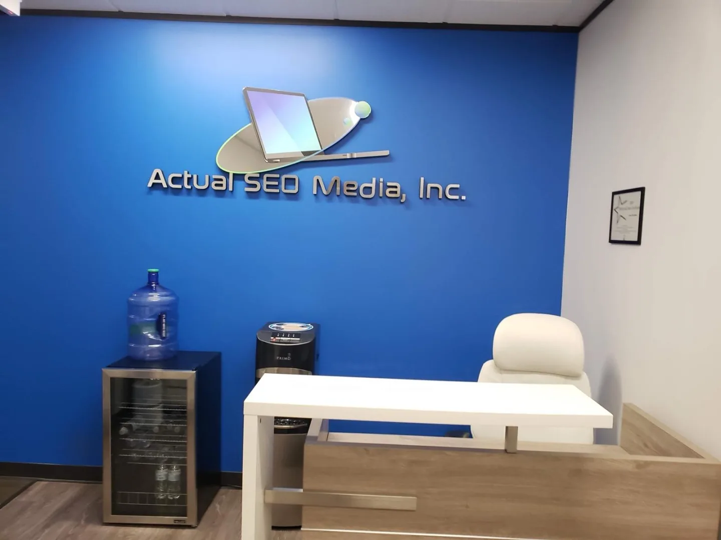 Blue accent-wall reception desk at our Dairy Ashford office