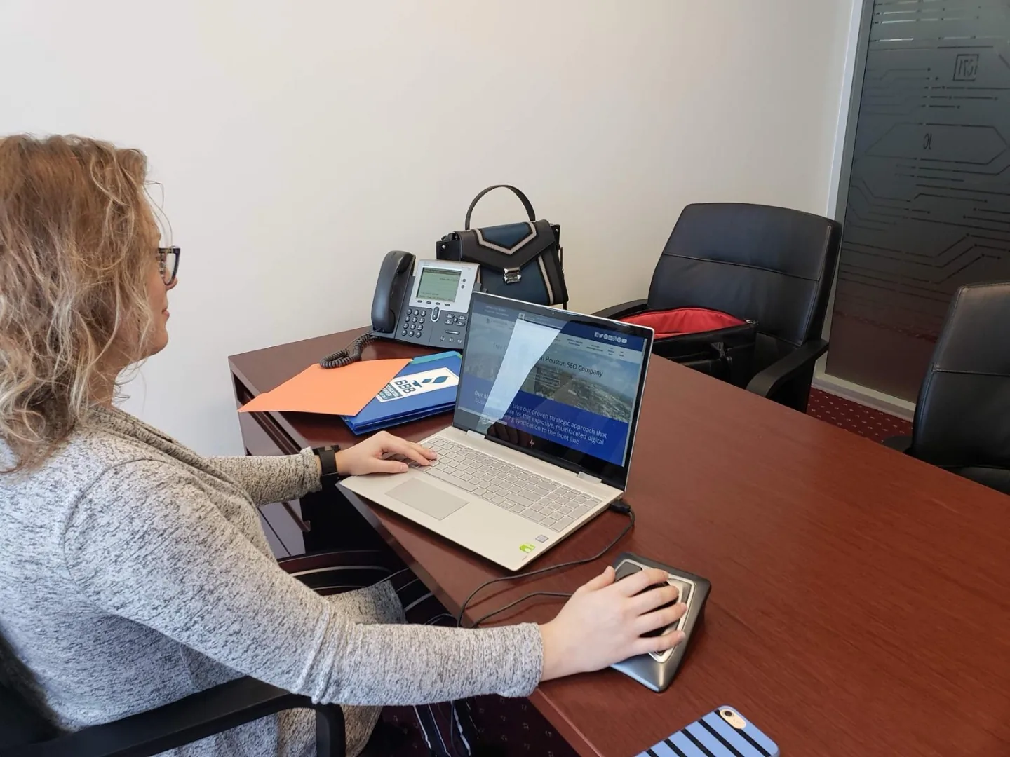 Actual SEO Media, Inc. team member reviewing a client website from our Williams Tower office desk