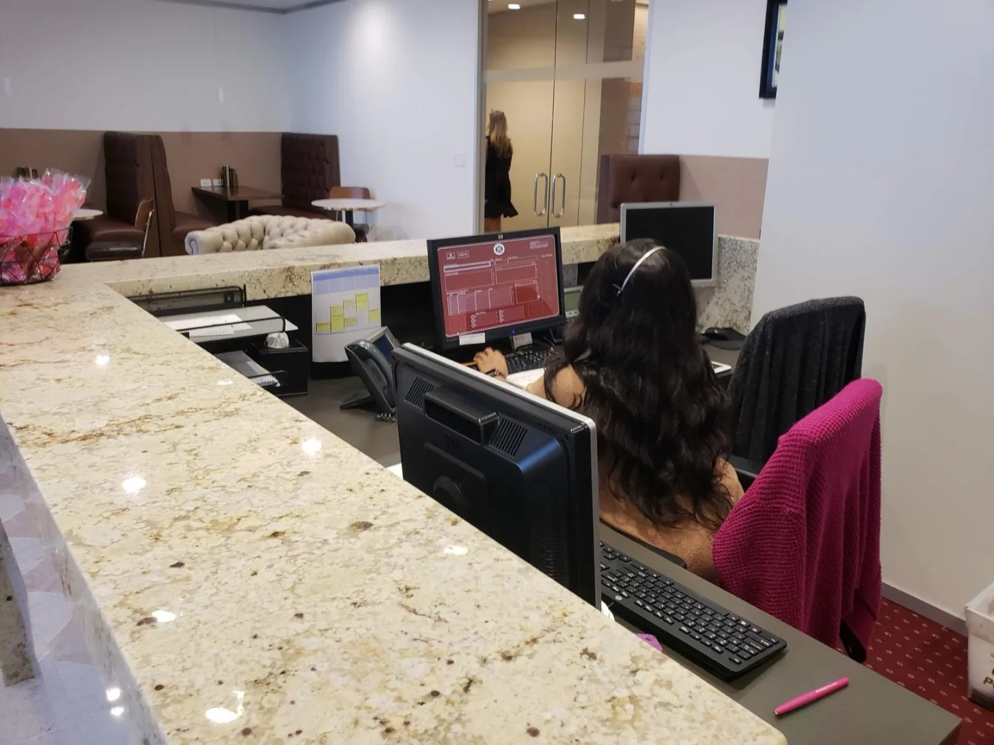 Front desk and phone booth seating area at our Williams Tower office reception