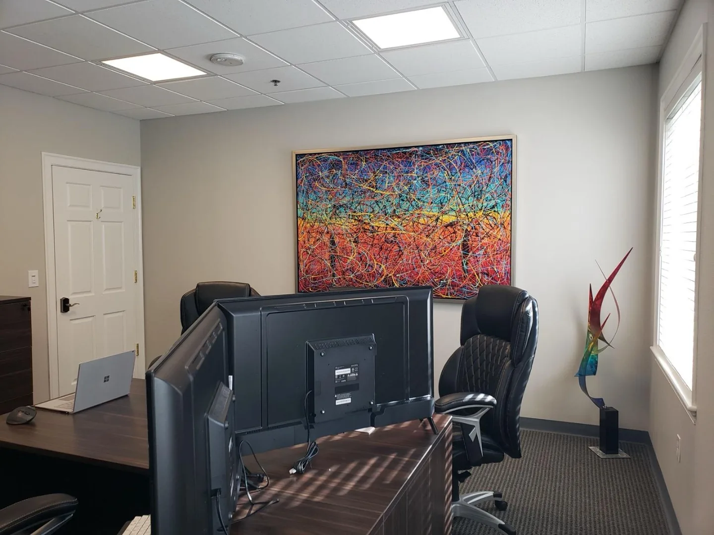 Small meeting room with modern artwork at our Woodlands office